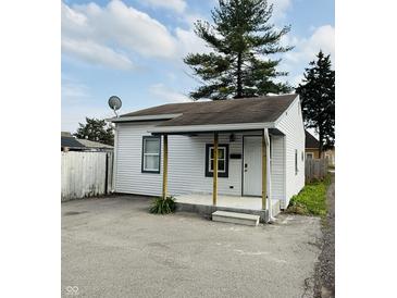 A charming home with a small front porch featuring wooden support beams, a white front door, and a satellite dish at 2342 Hoyt Ave, Indianapolis, IN 46203