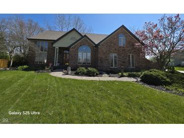 Beautiful brick home with a manicured lawn and landscaping, featuring a charming front walkway at 8429 Admirals Cv, Indianapolis, IN 46236
