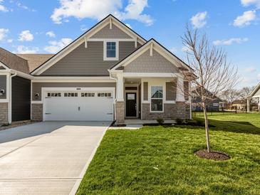 Charming craftsman-style home with a two-car garage, well-manicured lawn, and covered front porch at 16689 Cattle Hollow Ln, Noblesville, IN 46060