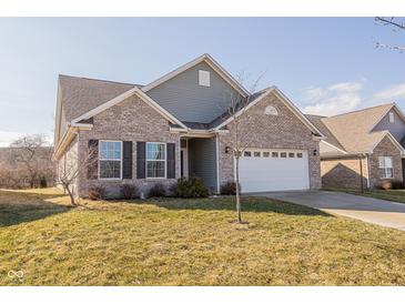 Charming, single-story home features a brick facade, attached two-car garage, and manicured front lawn at 5677 Starla Ln, Plainfield, IN 46168