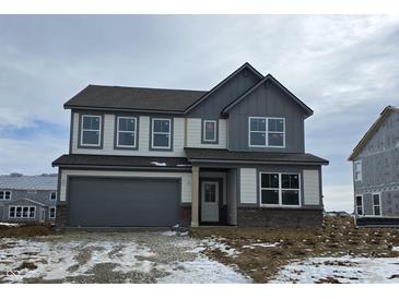 Two-story home with gray and white color scheme, attached garage, and snowy front yard at 1853 Grand Vista Blvd, Greenwood, IN 46143