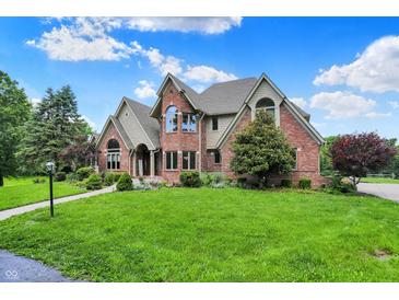 Stately brick home with manicured lawn and mature trees on a sunny day at 3592 W Smokey Row Rd, Bargersville, IN 46106