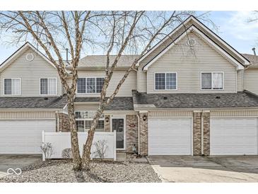 Charming townhouse featuring a one-car garage and well-maintained front yard at 5845 Shipwatch Pl, Indianapolis, IN 46237