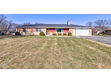 Brick ranch home with attached garage and a spacious lawn at 4522 Thornleigh Dr, Indianapolis, IN 46226
