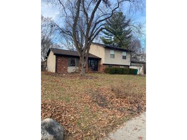 Brick ranch home with attached garage and mature trees at 3310 Acacia Dr, Indianapolis, IN 46214