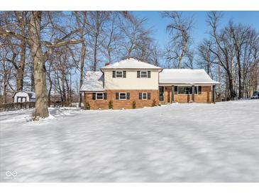 Two-story brick home with snowy front yard at 454 Tulip Dr, Mooresville, IN 46158