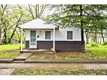 Charming single-story home with white siding, covered porch, and well-maintained front yard at 715 N Warman Ave, Indianapolis, IN 46222