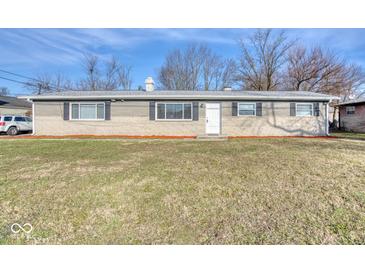 Ranch style home with brick exterior, landscaped lawn, and a spacious front yard at 8390 E Us 36 Hwy, Avon, IN 46123