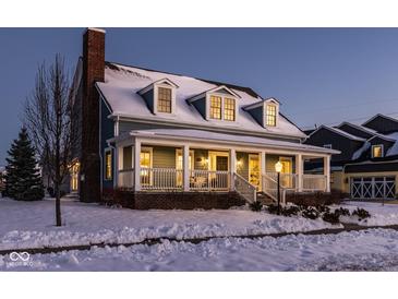 Two-story house with a wrap-around porch, brick facade, and snow-covered lawn at 13139 Broad St, Carmel, IN 46032