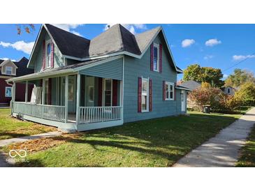 Charming two-story home with a covered porch, red shutters, and a well-maintained front yard at 538 N East St, Greenfield, IN 46140