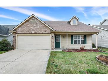Charming one-story home with a brick and vinyl facade, attached garage, and manicured front yard at 14944 Mia Dr, Carmel, IN 46033