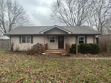 Tan one-story house with a small front porch and mature trees at 121 State St, Markleville, IN 46056