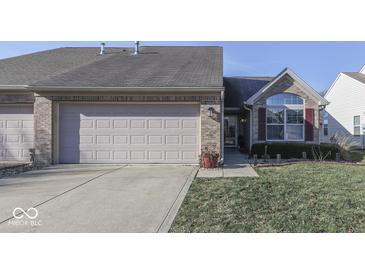 Brick ranch home with attached two-car garage and landscaped lawn at 2814 Cadogan Dr, Greenwood, IN 46143