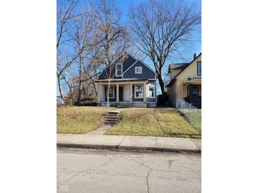 Charming two-story home with gray siding and a spacious front yard at 2955 N Olney St, Indianapolis, IN 46218