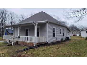 Gray siding house with a covered porch and well-maintained lawn at 499 N Indiana St, Danville, IN 46122