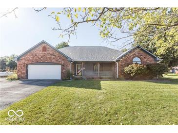 Brick ranch house with attached garage and covered porch at 5856 Cozy Dr, Pittsboro, IN 46167