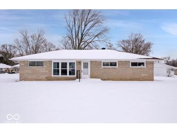 Ranch style home with snow covered front yard at 207 Stephen Ct, Carmel, IN 46280