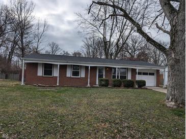 Brick ranch home with attached garage and landscaping at 2307 Bramble Way, Anderson, IN 46011