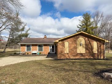 Attractive brick ranch featuring an attached garage, well-maintained landscaping, and a spacious driveway at 3699 Lisa Ln, Plainfield, IN 46168