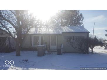 Tan single story home with snow covered yard at 5473 E 19Th St, Indianapolis, IN 46218