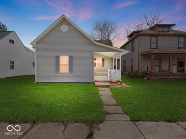 Charming home with a well-maintained lawn, inviting porch and stone walkway, great for curb appeal at 619 Fair Ave, Shelbyville, IN 46176