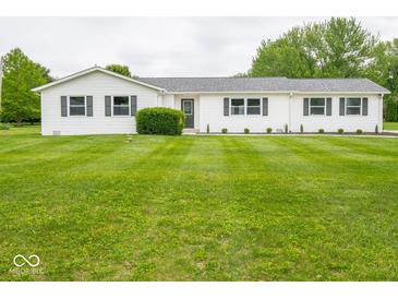 Charming one-story home with white siding, black shutters, and a lush green front lawn at 901 N 700 W, Greenfield, IN 46140