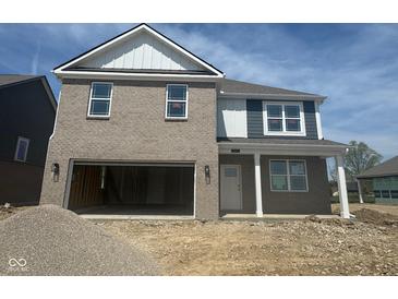 New two-story home with brick and siding, attached garage, and covered porch at 1350 Foxtail Ln, Greenwood, IN 46143