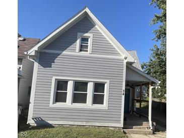 Gray house with white trim, three windows, and a covered porch at 34 Iowa St, Indianapolis, IN 46225
