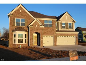 Beautiful two-story brick home with a two-car garage and manicured front yard at 1069 Ridgevine Rd, Greenwood, IN 46143