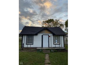 Newly renovated home exterior boasts white siding and a black roof at 2722 Collier St, Indianapolis, IN 46241