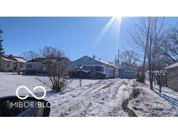 Cute bungalow on a snowy lot with a detached garage at 3915 Brookville Rd, Indianapolis, IN 46201