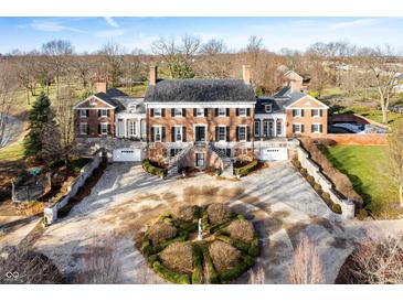 Impressive brick manor house with circular driveway and manicured landscaping at 4601 N Legacy Dr, Muncie, IN 47304