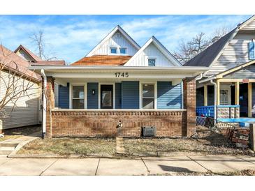 Charming blue house with brick details and a welcoming front porch at 1745 S Talbott St, Indianapolis, IN 46225