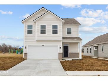 Charming two-story home with a two car garage and manicured front lawn at 1845 James Pierce Dr, Shelbyville, IN 46176