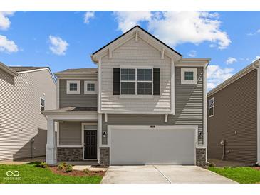 Charming two-story home with gray siding, white accents, and an attached two-car garage at 5123 Rolling Meadow Blvd, Indianapolis, IN 46237