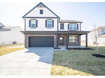 Charming two-story home featuring a modern exterior with black trim and attached two-car garage at 801 Blaine Dr, Whiteland, IN 46184