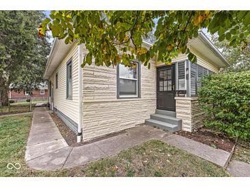 Charming bungalow with stone accents and a landscaped front yard at 1921 E Pleasant Run Pkwy S S Dr, Indianapolis, IN 46203