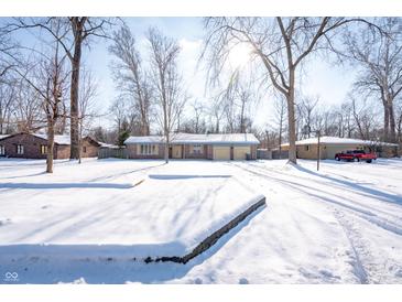 Brick ranch home with snow-covered yard at 345 E Hickory Ln, Indianapolis, IN 46227