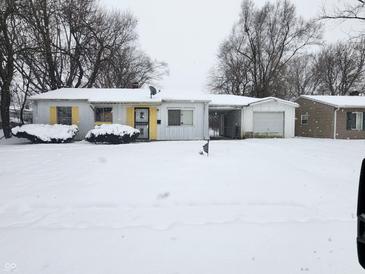 Ranch home with attached garage, covered by snow at 5807 Westhaven Dr, Indianapolis, IN 46254