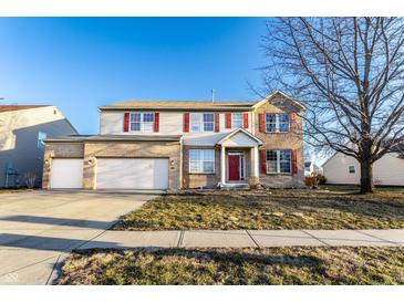 Charming two-story home with a two-car garage and well-maintained front lawn, perfect for suburban living at 5838 W Bayfield Dr, McCordsville, IN 46055