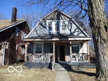 Charming two-story home featuring a inviting front porch and classic architectural details at 1138 W 33Rd St, Indianapolis, IN 46208