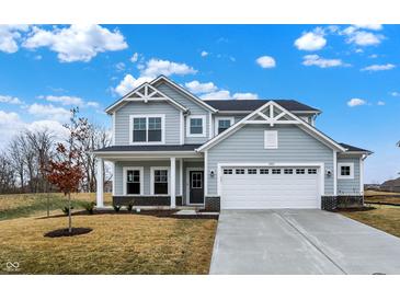 Charming two-story home featuring a two-car garage, covered porch, and gray siding with white trim at 4103 Railhead Ave, Westfield, IN 46074