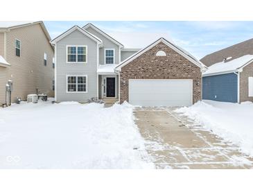 Two-story brick home with attached garage, snow covered front yard at 4351 Ringstead Way, Indianapolis, IN 46235