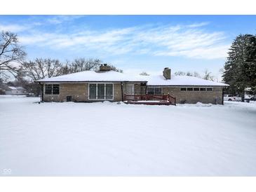 Ranch home exterior, snow covered yard, wood deck at 457 S High School Rd, Indianapolis, IN 46241