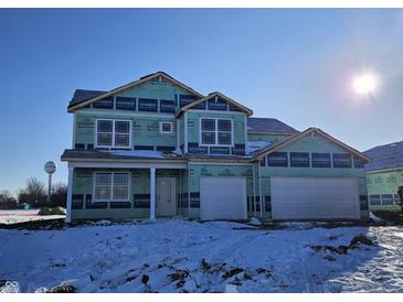 New construction home exterior; white siding, white garage door, and snow covered yard at 6039 Granby Dr, Whitestown, IN 46075