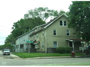 Two-story home with painted siding, framed windows, partial basement and covered porch at 3469 N Capitol Ave, Indianapolis, IN 46208