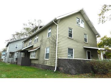 Two story house with green siding and a brick base at 3469 N Capitol Ave, Indianapolis, IN 46208