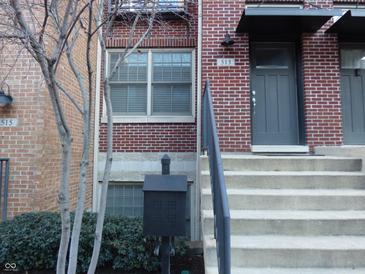 Brick front exterior of home with gray door and steps at 513 N Park Ave, Indianapolis, IN 46202