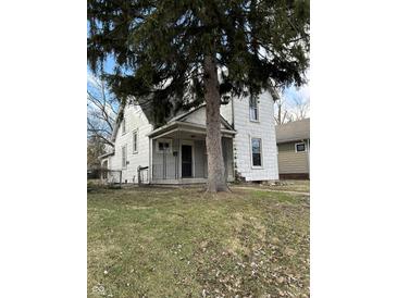 Two-story house with front porch and mature tree at 136 S Spencer Ave, Indianapolis, IN 46219