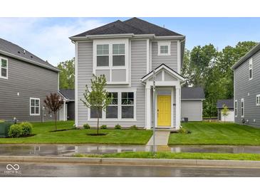 Charming two-story home with a bright yellow front door and well-manicured lawn at 1709 Real St, Indianapolis, IN 46240